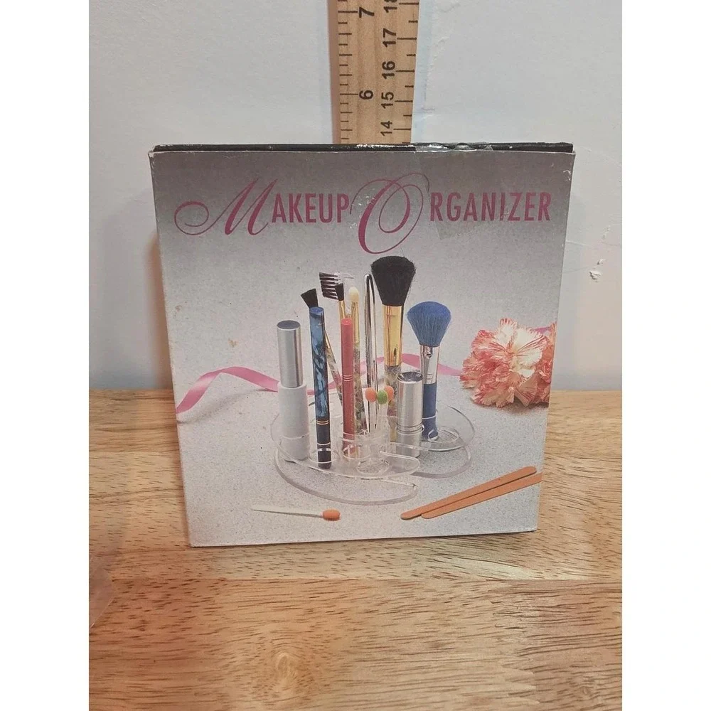 1990s NOS clear acrylic makeup organizer featuring tiered slots for holding